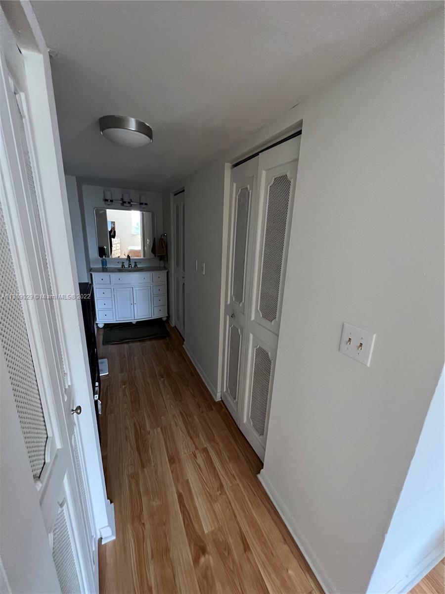 1665 Bay Road, Unit 517 Miami Beach, FL 33139 - Photo 17 of 26 a room with wooden floor and furniture