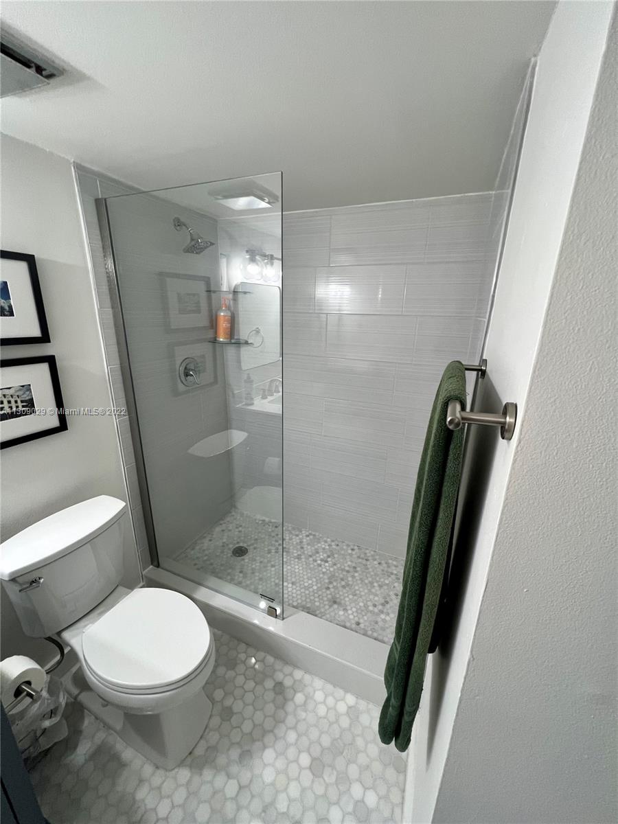 1665 Bay Road, Unit 517 Miami Beach, FL 33139 - Photo 5 of 26 a bathroom with a toilet and a shower