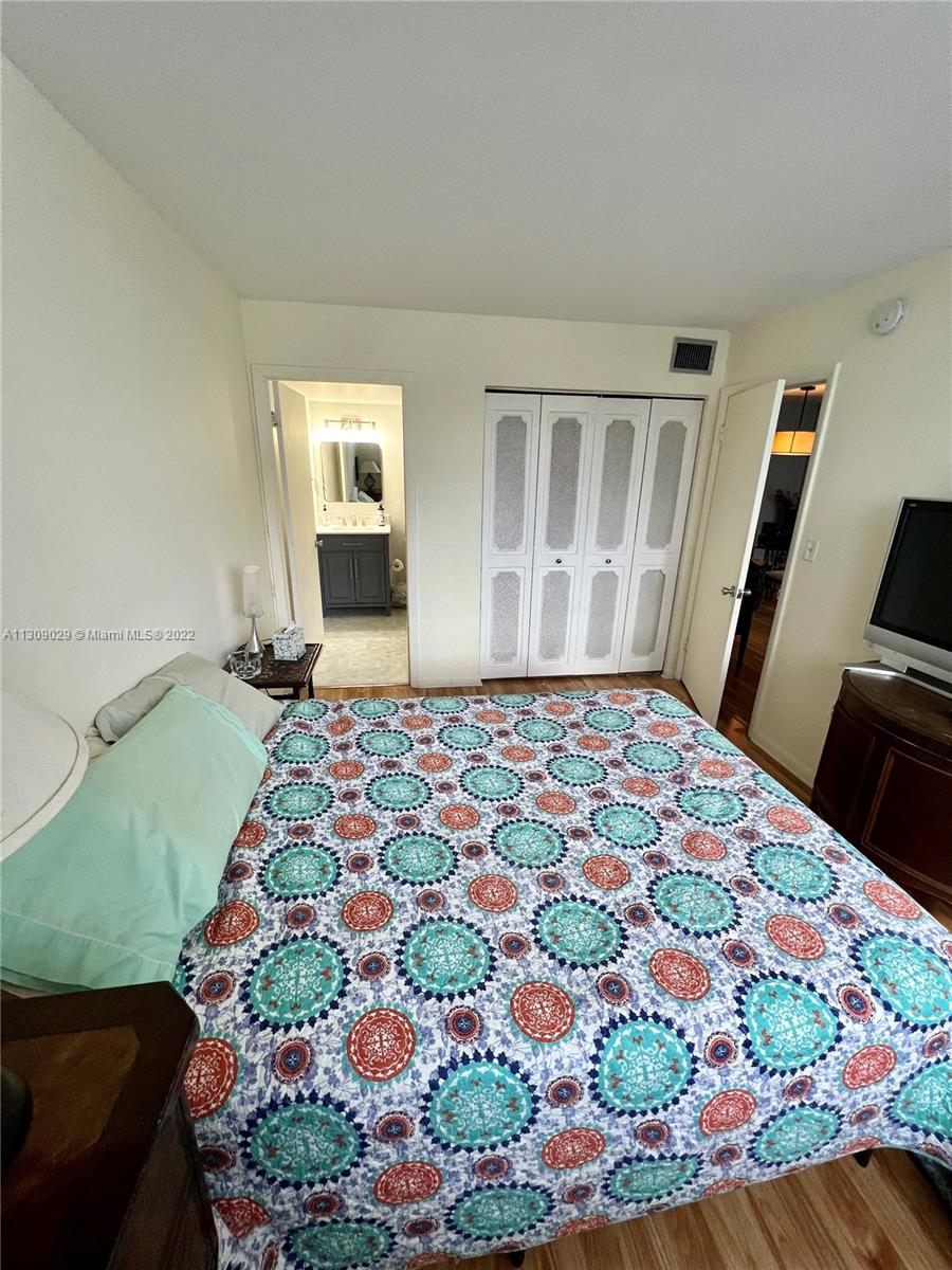 1665 Bay Road, Unit 517 Miami Beach, FL 33139 - Photo 7 of 26 a bedroom with a bed and a flat screen tv