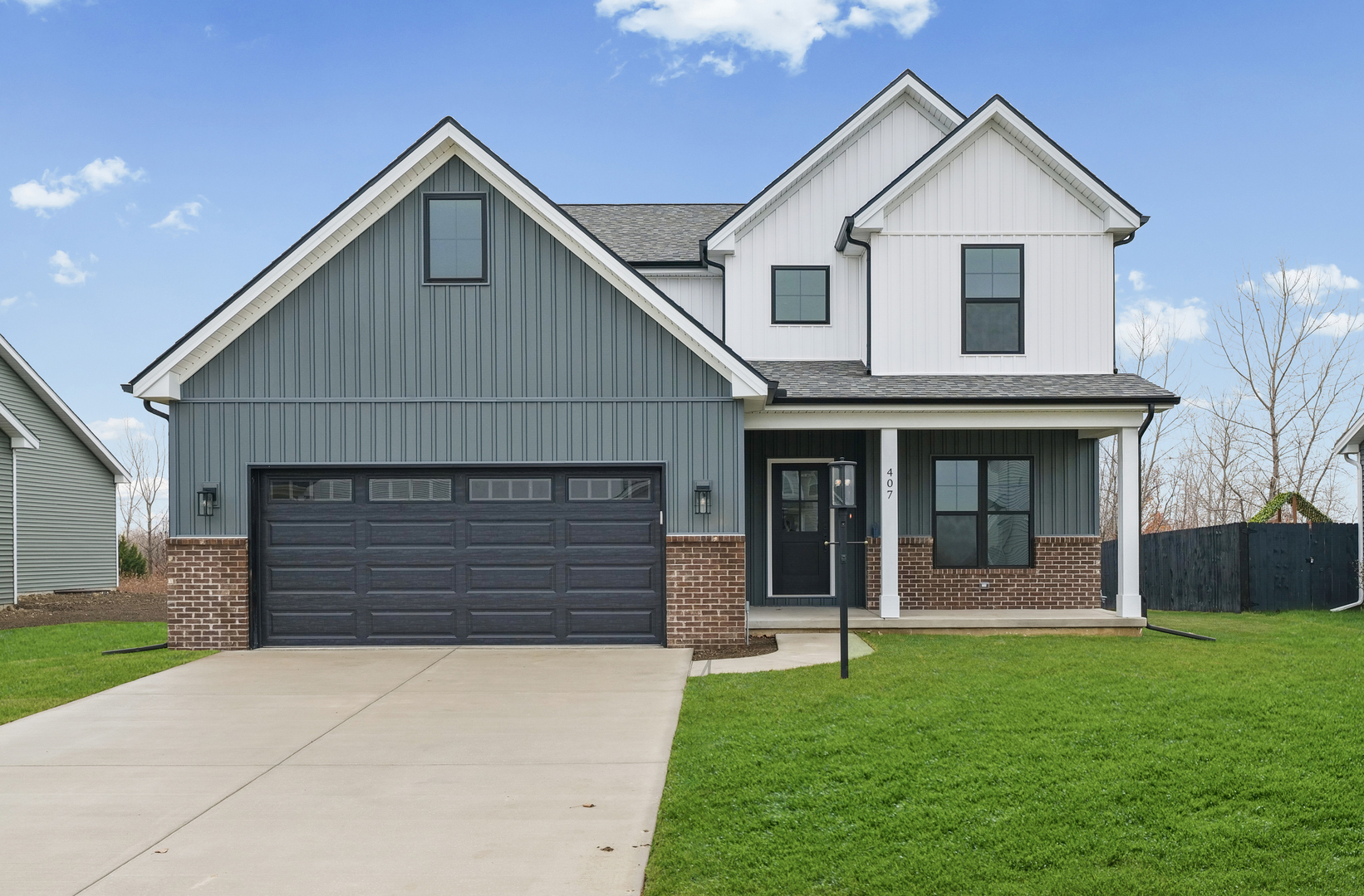 407 Harpers Ferry Savoy, IL 61874 - Photo 1 of 31 a front view of a house with a yard and garage