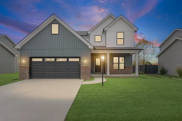 a front view of a house with a yard and garage