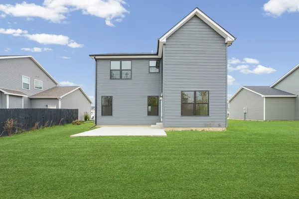 a front view of house with yard and garage