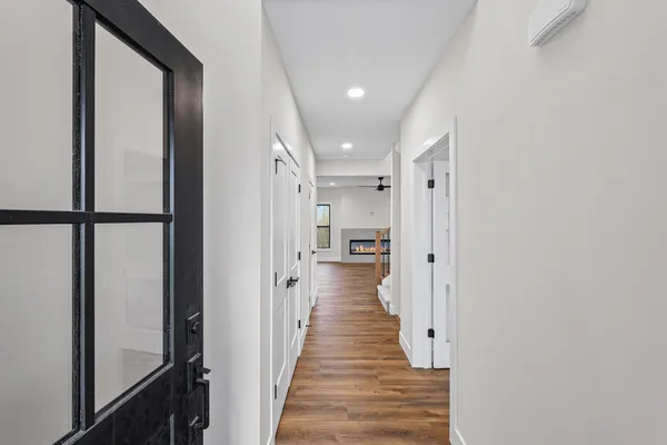 a view of a hallway with wooden floor and staircase