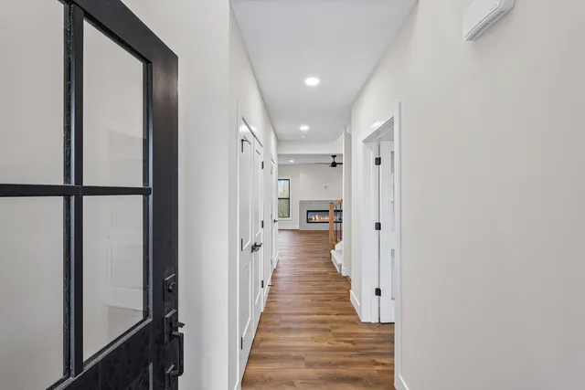 a view of a hallway with wooden floor and staircase