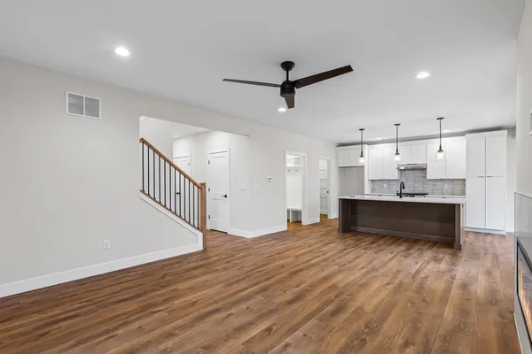 a view of a big room with wooden floor and windows