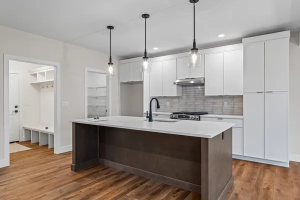 a kitchen with kitchen island a sink stainless steel appliances and cabinets