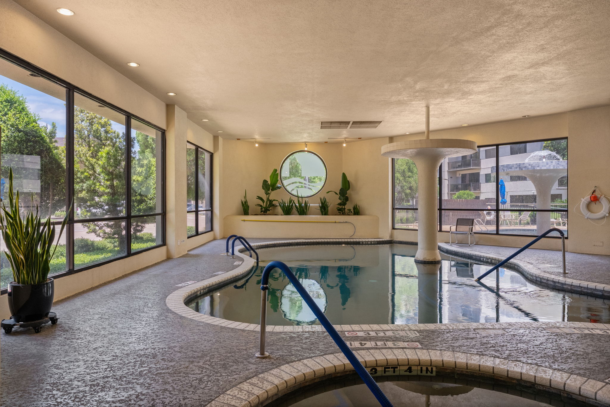 40 North Interstate Highway 35, Unit 11B2 Austin, TX 78701 - Photo 20 of 28 An inviting indoor pool with large windows allows natural light to fill this recreational area.