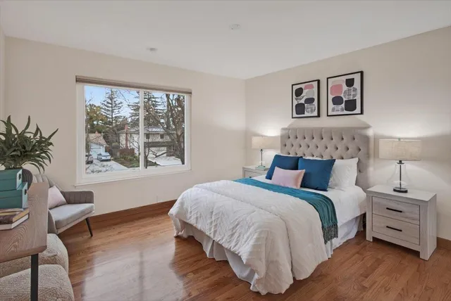 a bedroom with a bed and wooden floor