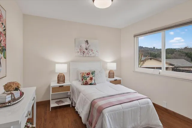 a bathroom with a granite countertop sink a toilet and mirror
