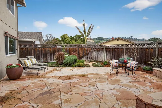 a view of a patio with table and chairs and potted plants