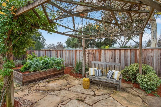 a front view of a house with a garden and sitting area
