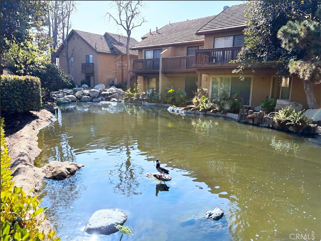 a view of a lake with a house in the background