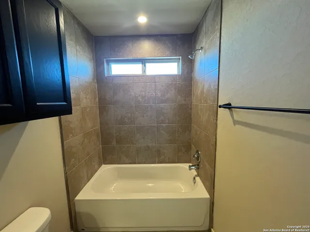 a bathroom with a shower and toilet