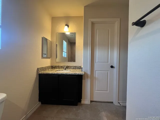 a view of a bathroom with a sink and a mirror