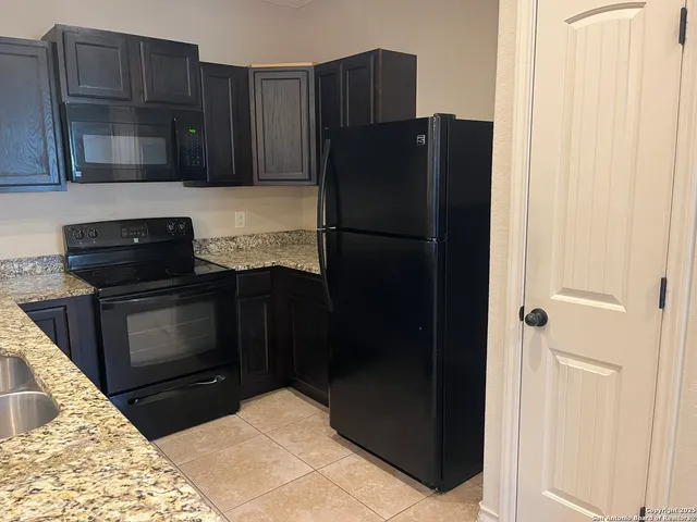 a kitchen with a refrigerator and a stove