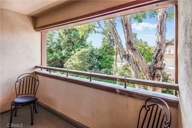 a view of a chair and table in the balcony