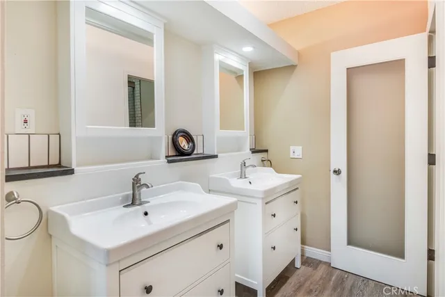 a bathroom with 2 sink and a mirror