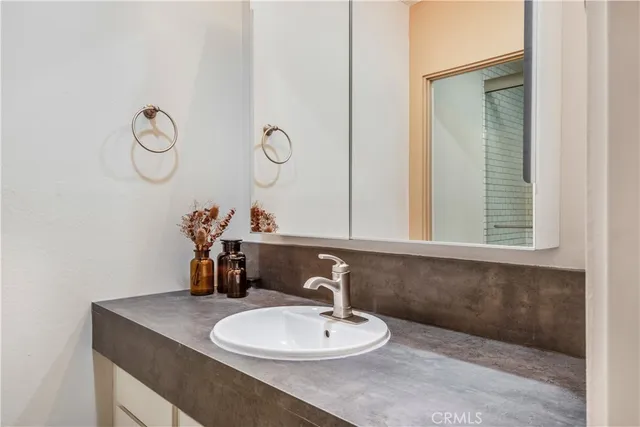 a bathroom with a sink a mirror and vanity