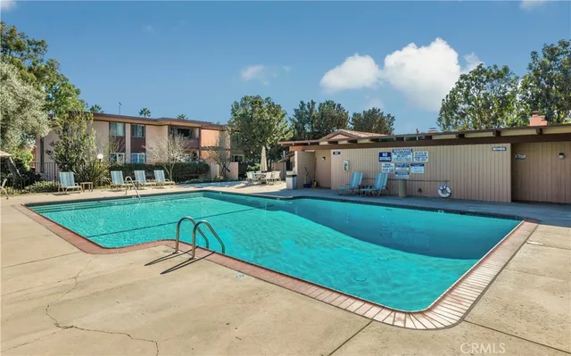 a swimming pool with outdoor seating and yard