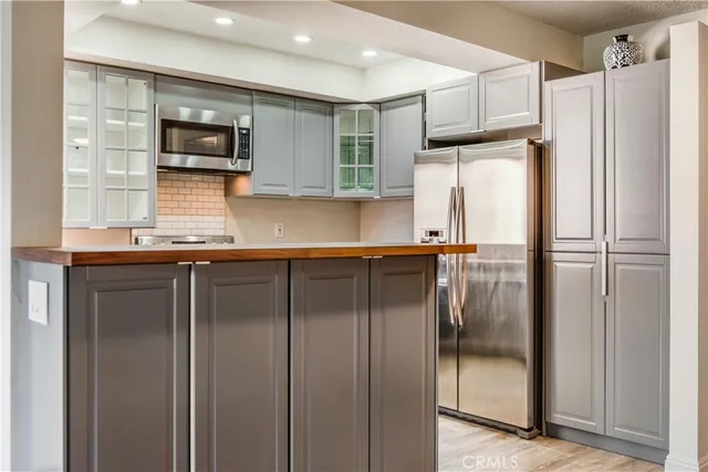 a kitchen with a refrigerator and a sink