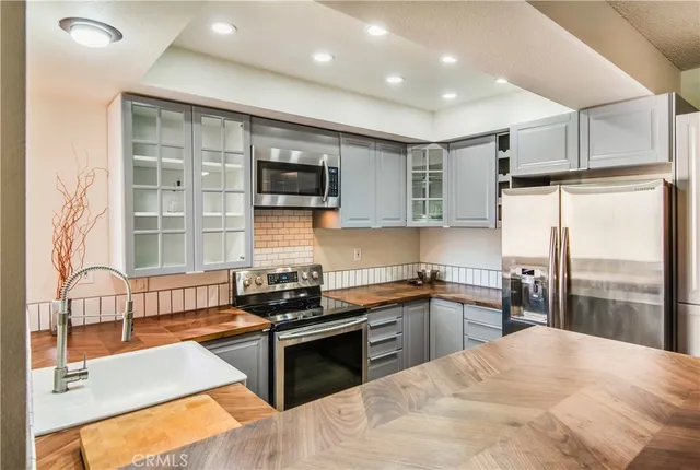 a kitchen with stainless steel appliances granite countertop a stove and a sink