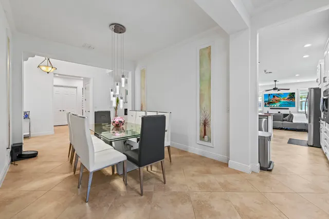 a large white kitchen with stainless steel appliances granite countertop a sink and dishwasher a stove with wooden floors