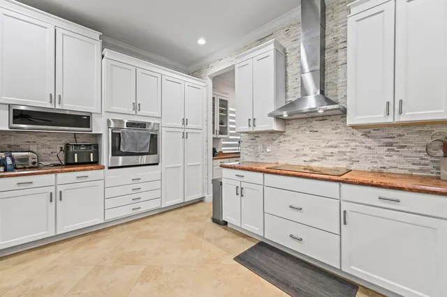 a living room with furniture flat screen tv and a chandelier