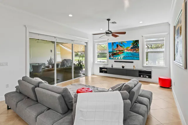 a bedroom with furniture and a large window