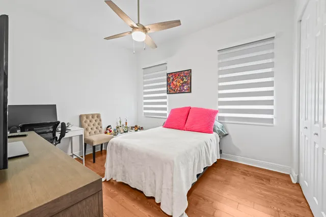 a bedroom with a bed and a desk