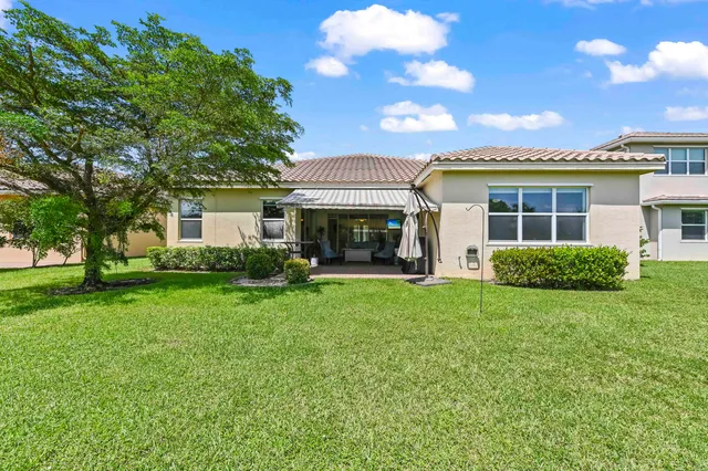 a view of a house with a yard and a lake view