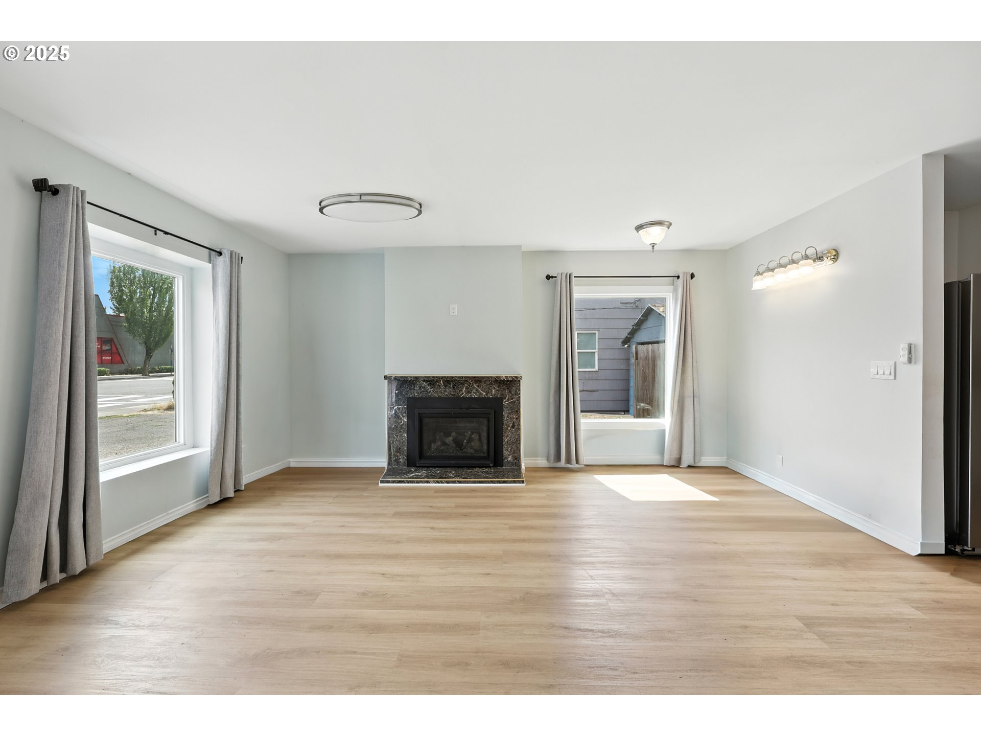 1611 Northeast 102nd Avenue Portland, OR 97220 - Photo 8 of 30 a view of an empty room with wooden floor and a window