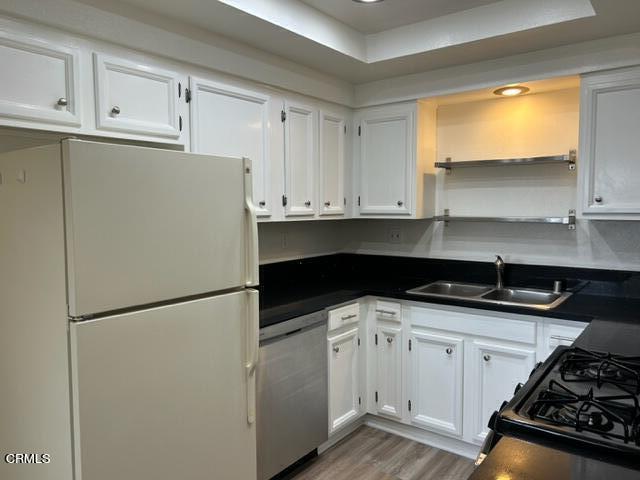 4907 Dunes Street, Unit 7 Oxnard, CA 93035 - Photo 12 of 74 a kitchen with granite countertop a refrigerator sink and cabinets