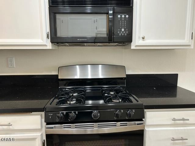 4907 Dunes Street, Unit 7 Oxnard, CA 93035 - Photo 13 of 74 a stove top oven sitting inside of a kitchen
