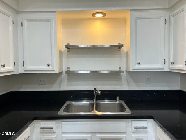 4907 Dunes Street, Unit 7 Oxnard, CA 93035 - Photo 14 of 74 a kitchen with a sink and cabinets