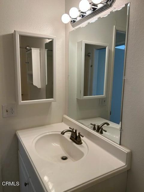 4907 Dunes Street, Unit 7 Oxnard, CA 93035 - Photo 36 of 74 a bathroom with a sink and a mirror