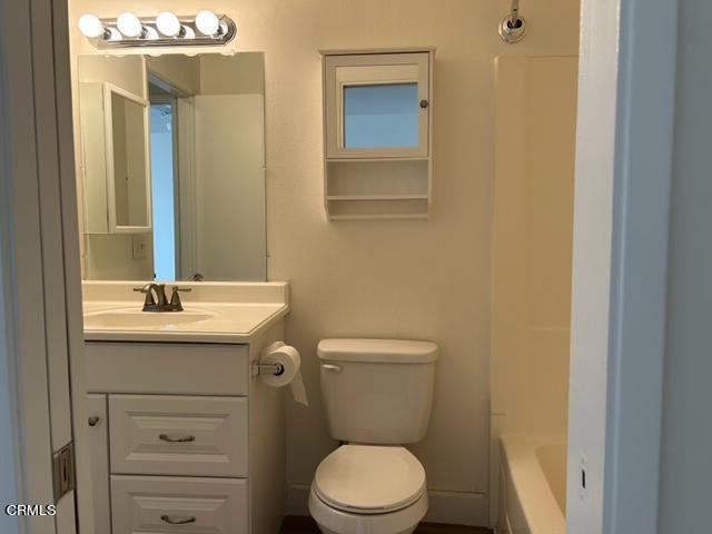 4907 Dunes Street, Unit 7 Oxnard, CA 93035 - Photo 37 of 74 a bathroom with a granite countertop toilet a sink and mirror