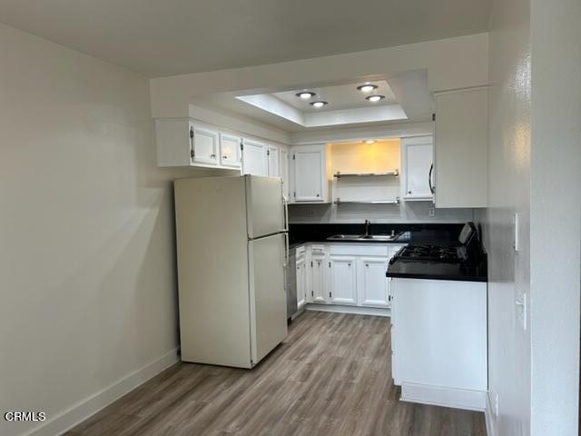4907 Dunes Street, Unit 7 Oxnard, CA 93035 - Photo 8 of 74 a kitchen with a refrigerator and a stove top oven