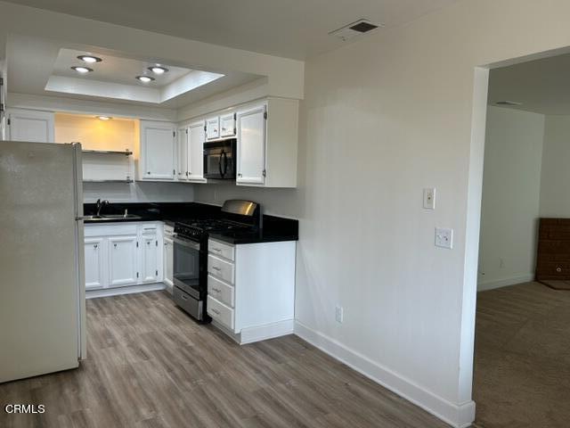 4907 Dunes Street, Unit 7 Oxnard, CA 93035 - Photo 9 of 74 a kitchen with a sink a stove and cabinets