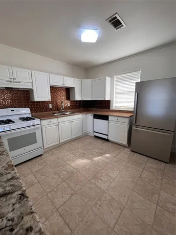 a kitchen with a cabinets and appliances