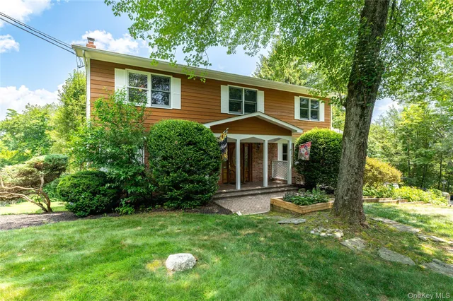 a front view of house with a garden