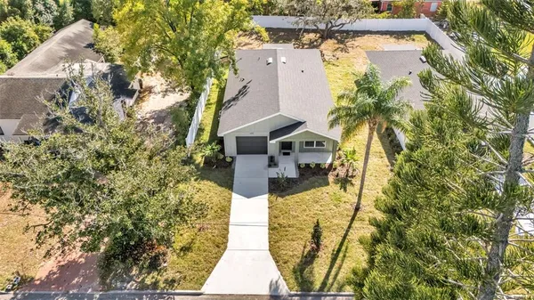an aerial view of a house with a yard and lake view
