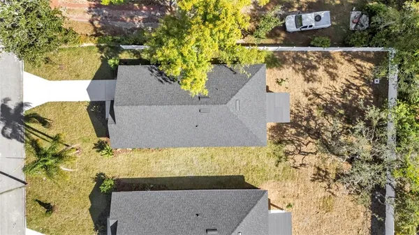 an aerial view of residential houses with outdoor space