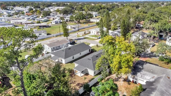an aerial view of residential houses with outdoor space