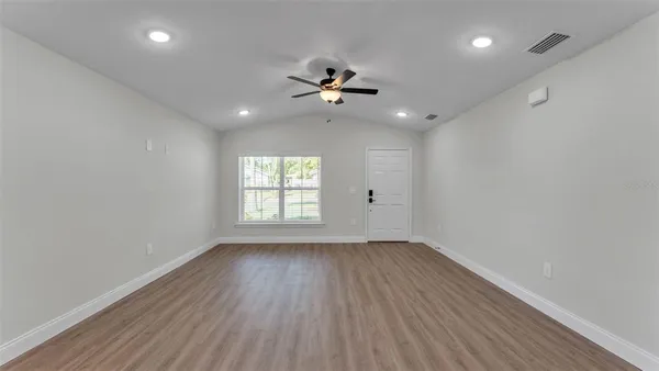 a large kitchen with granite countertop a large counter top stainless steel appliances and cabinets