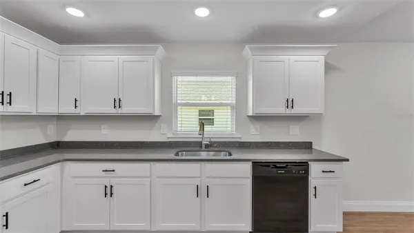 a kitchen with a refrigerator and a stove top oven