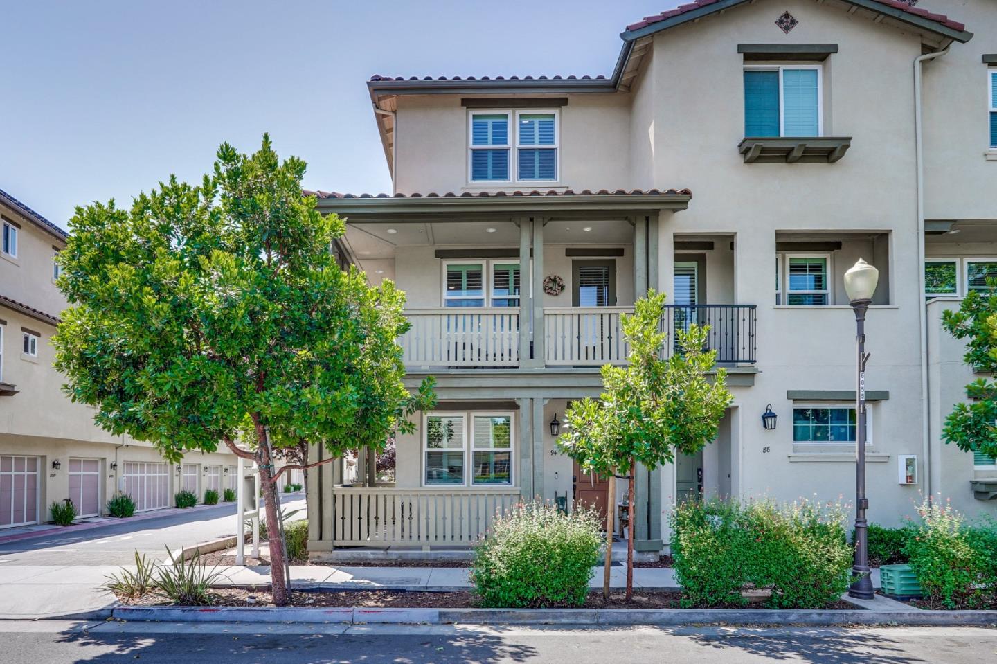 a front view of a house with plants