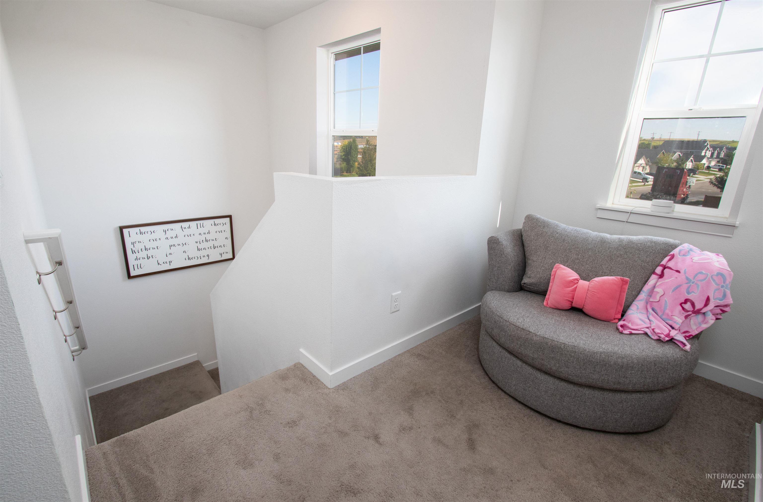 7698 South Seabreeze Way Boise, ID 83709 - Photo 12 of 16 Living area featuring an upstairs landing and carpet flooring