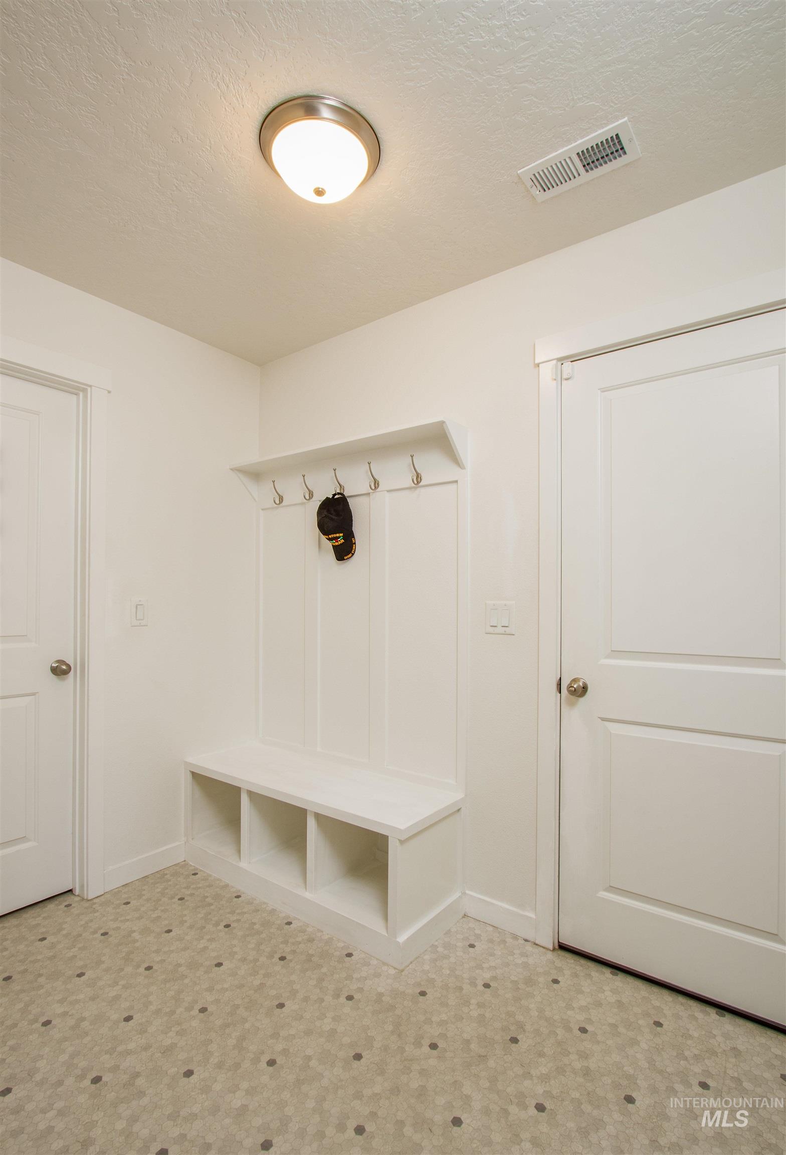 7698 South Seabreeze Way Boise, ID 83709 - Photo 13 of 16 Mudroom with a textured ceiling