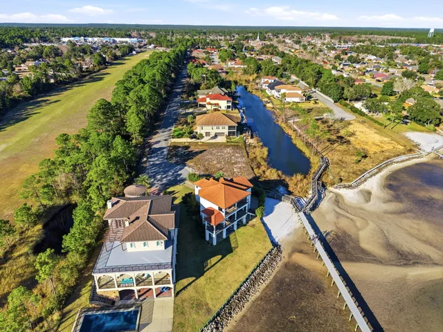 a view of a house with a yard and lake view