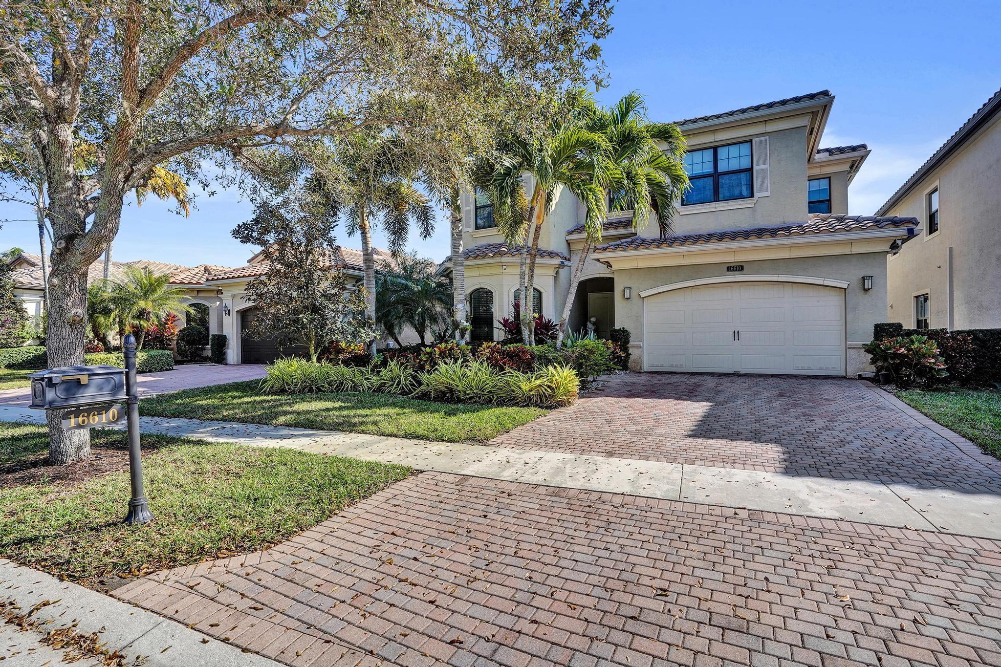 16610 Gateway Bridge Drive Delray Beach, FL 33446 - Photo 32 of 67 a front view of a house with a yard and garage